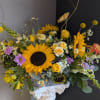 This beautiful flower arrangement of fresh mixed seasonal blooms is made by