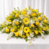 Sunlit yellow roses and cheerful yellow gerbera daisies take center stage in