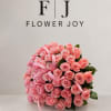 A luxurious arrangement of soft pink roses, beautifully gathered with delicate ribbon