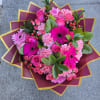 Pink bouquet with roses, gerbera daisies, and carnations in decorative wrap