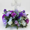 A clear crystal cross surrounded by a halo of silk blooms creates