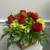 Red roses arranged with green hydrangeas in a square wooden container