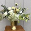 Soft white roses and pale green hellebores mingle with airy white hydrangea