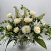 White roses and chrysanthemums in a white pedestal vase
