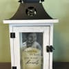Decorative memorial lantern with a candle and photo inside