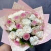 Bouquet of pink and white roses wrapped in pink paper