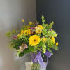 This beautiful flower arrangement of fresh mixed seasonal blooms is made by