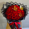 Bouquet of red roses wrapped in black paper with butterfly decorations
