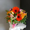 This beautiful flower arrangement of fresh mixed seasonal blooms is made by