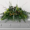 A serene cascade of pale green hydrangeas and small sunflower heads creates