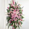 Tall pink floral standing spray on an easel with lilies and roses