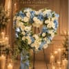 This is a heart-shaped standing floral spray designed with a serene and