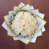 Creamy white roses form a lush, rounded wedding bouquet that reads soft