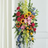 Tall cascading spray of hot pink roses, yellow sunflowers, pink lilies and