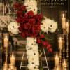 A arrow-shaped cross tribute crafted with deep red roses, symbolizing love and