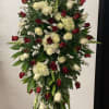 Tall standing floral spray with red and white roses and cream hydrangeas