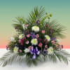 Large floral arrangement with pink, white, and purple flowers and palm fronds