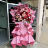 Red, blush, peach and white roses and carnations arranged on a wooden