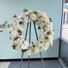 White rose, orchid and hydrangea wreath with soft accents on a tall
