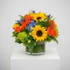 Blue hydrangeas and sunflowers accented with yellow and orange roses and greens