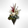 Dried floral wall arrangement with white blooms and burgundy grasses in a decorative cone holder