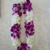 A lush loop of clustered white and purple orchids makes an unforgettable