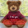 A classic dozen long-stem red roses arranged in a clear textured glass