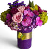 Roses orchid and more arranged in a tall modern glass cylinder vase