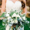 Bride holding a white bouquet with eucalyptus greenery