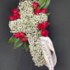 An elegant cross of white baby's breath accented with roses of your