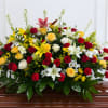 Large casket spray with red, yellow, and white flowers
