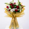Hand-tied bouquet of red and white roses with white accent flowers wrapped in gold cellophane and ribbon.
