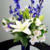Blue and white flower arrangement in a tall cobalt vase
