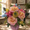 Soft pink-and-peach roses take center stage in this cheerful birthday bouquet, arranged
