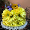 Yellow daisy bouquet with purple accents and striped candles