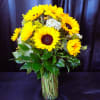 Bouquet of yellow sunflowers in a clear glass vase