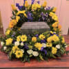 The Sunlit Skies Urn Arrangement is a radiant and heartfelt tribute designed