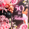 Pink and black balloon display beside a 