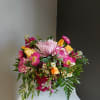 This beautiful flower arrangement of fresh mixed seasonal blooms is made by
