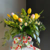 This beautiful flower arrangement of fresh mixed seasonal blooms is made by