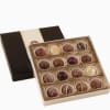 Decadent , smooth assorted truffles in a decorative gift box. 