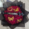 Bouquet of red roses wrapped in black paper with gold butterfly decorations
