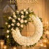 Beautiful white wreath with roses and greenery.