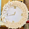 A refined circular wreath of cream roses and white orchids arranged around