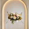 Beautiful compact arrangement with a mix of cream, peach and a hint