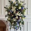 A formal standing spray that honors a loved one with a clear