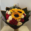 Bouquet of red and white roses with sunflowers in black wrap