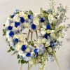 A large heart-shaped wreath in cool blues and whites creates an immediate