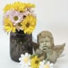 A burst of sunny daisies in bright yellow, soft pink and crisp