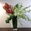 Anthurium stems , Dendrobium Orchid blooms ,green in mid size glass vase